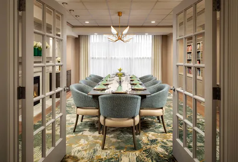 Private dining room with a long table and bookshelves