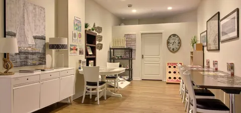 Activity room with tables, cupboards and a communal kitchen