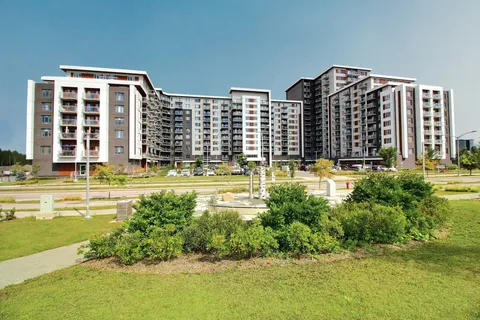 Residence exterior beside lawns and landscaped walking paths