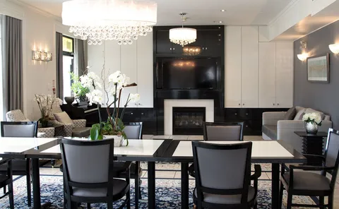Shared lounge and dining area with tables, armchairs and sofas.