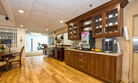 Coffee and serving area with cabinets and countertop.