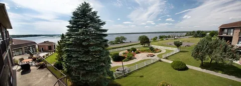 View over landscaped gardens and walking paths beside the river.