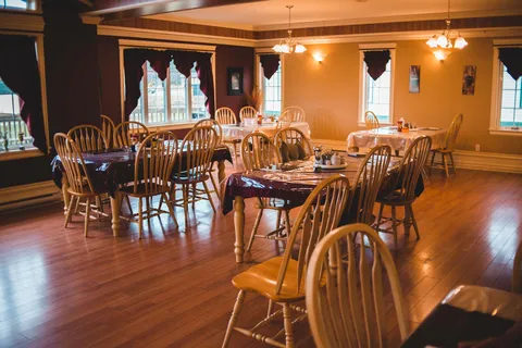 Dining room with wooden tables and chairs.