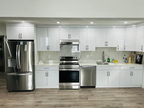 Kitchen with white cabinets, a sink and stainless-steel appliances.
