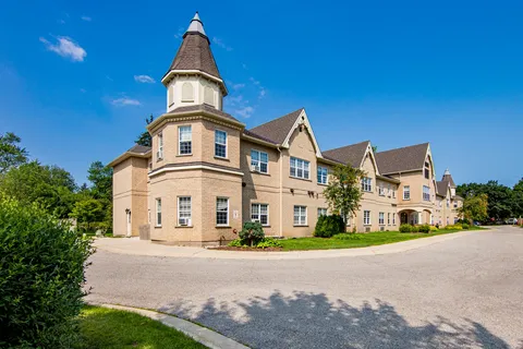 Anne Hathaway residence with a corner tower and driveway.