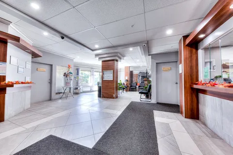 Entrance lobby with tiled floors, reception counters and seating.
