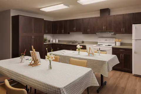 Activity kitchen with tables, cupboards and appliances
