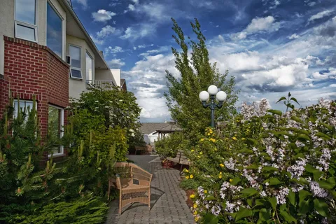 Garden path beside the residence and flowering shrubs
