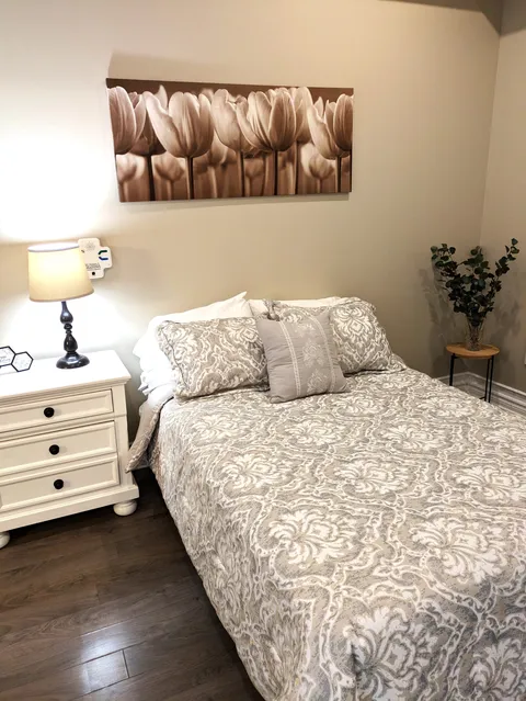 Bedroom with a double bed, bedside drawers and a flower picture