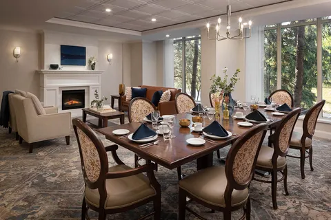 Private dining room with a set table and a fireplace.