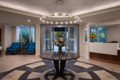 Entrance lobby with a reception counter and round flower table.