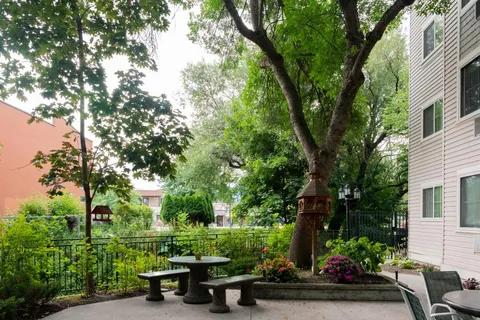 Courtyard with a picnic table, trees and flower beds