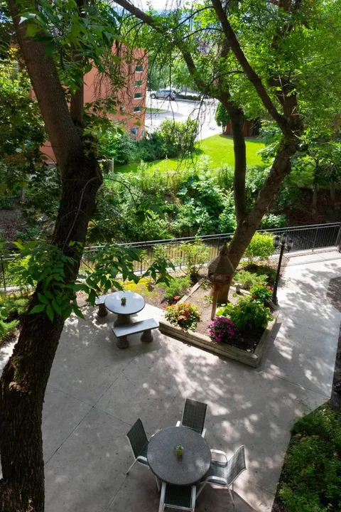 Overhead view of a courtyard with tables, chairs and raised flower beds