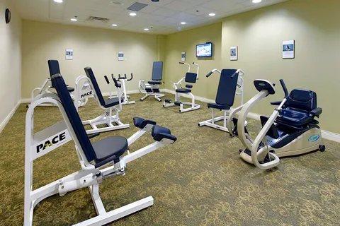 Fitness room with a row of strength training machines.