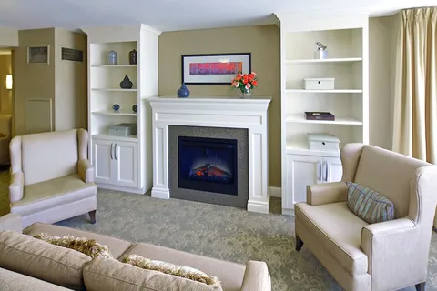 Lounge with sofas, armchairs and a fireplace.