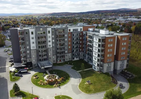 Aerial view of a residence with balconies around a circular driveway