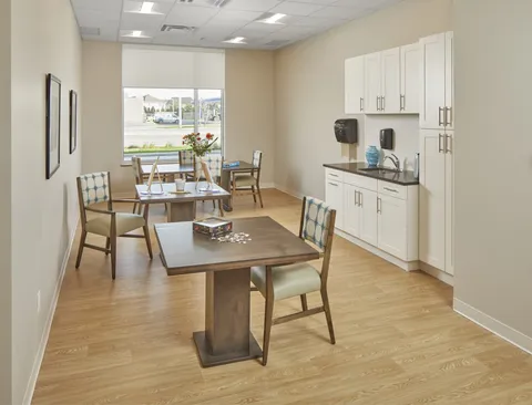 Room with tables, chairs, cabinets and a sink