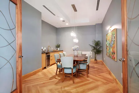 Private dining room with long table and pale blue chairs