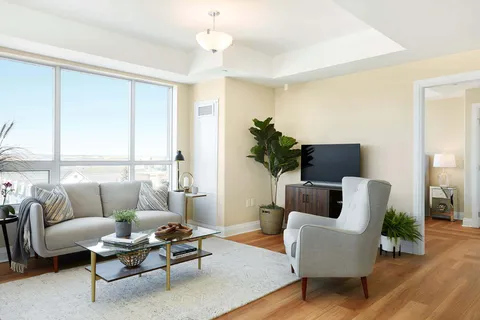 Suite living room with sofa, armchairs and city view