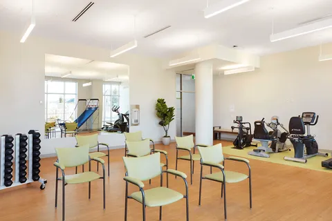 Fitness centre with exercise machines and rows of chairs