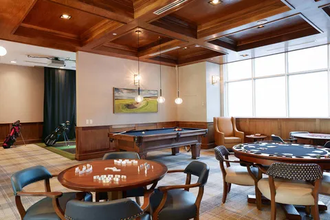 Games room with billiards and card tables