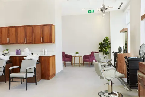 Hair salon with styling chairs and a kitchenette