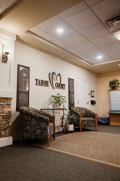 Lobby sitting area beside the Tabor Court wall sign.
