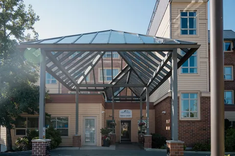 Building exterior with a glass-roofed entrance canopy.
