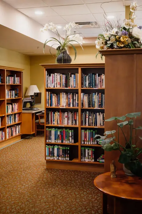 Library area with bookcases and a round table.