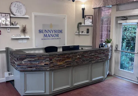 Reception counter and entrance lobby with floral arrangements.