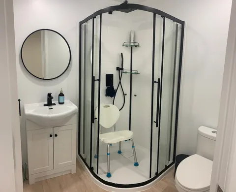 Bathroom with a walk-in shower, sink and toilet.