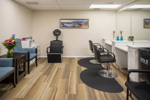 Hair salon with styling chairs, mirrors and a hood dryer