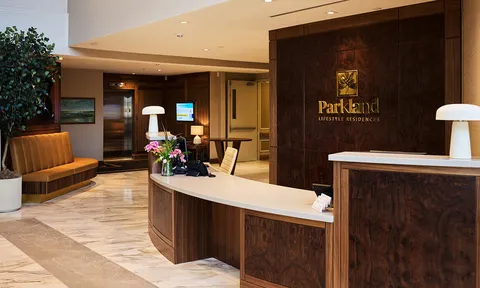 Reception counter with wood panelling and lobby benches