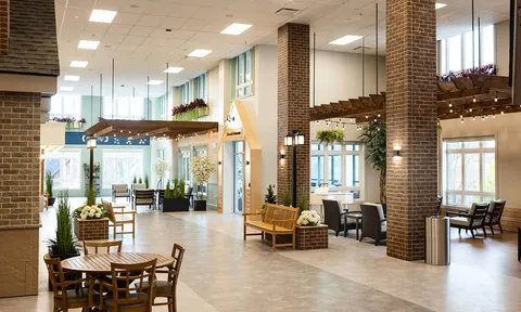 Tall entrance lobby with seating and brick columns
