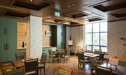 Cafe seating beneath a wood panelled ceiling