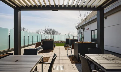 Roof terrace seating beneath a slatted pergola