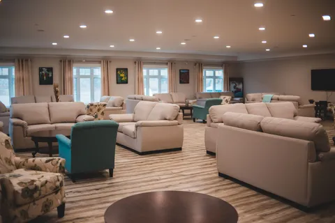 Large lounge with sofas and upholstered seating.