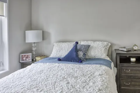 Bedroom with a bed, nightstands and upholstered headboard.