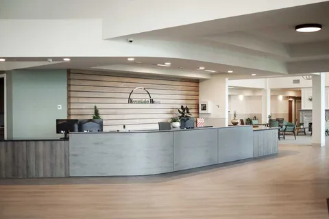 Reception counter beside an open corridor and seating