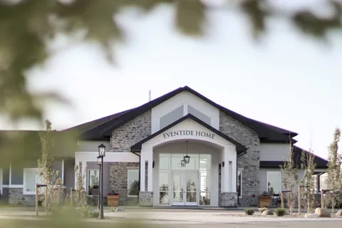 Building with a gabled entrance, stone walls and glass doors