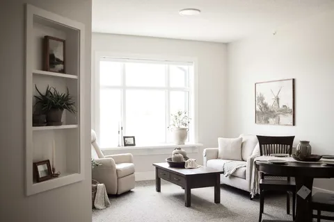 Sitting area with a sofa, armchair, coffee table and dining table