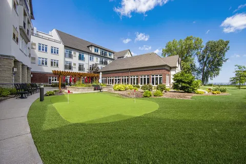 Putting green and flower beds beside the residence building