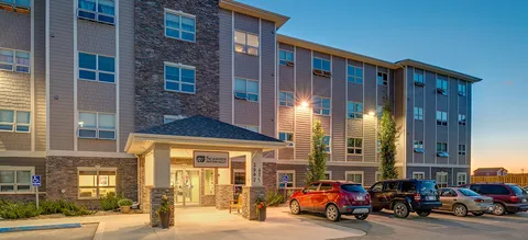 Building entrance and parked cars at dusk