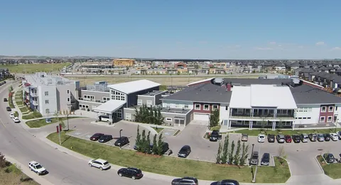 Aerial view of the residence, its entrance and surrounding parking areas