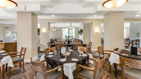 Dining room with set tables, wooden chairs and pendant lights