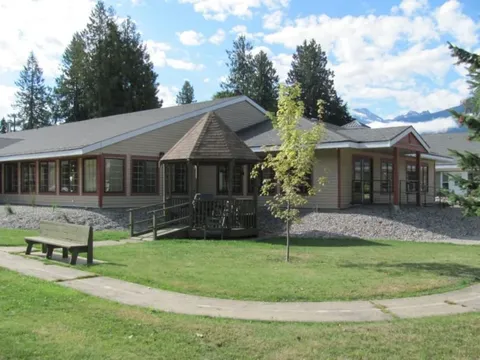 Single-storey residence with a gazebo, lawn, path and wooden bench