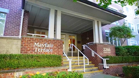 Covered entrance with steps, railings and brick walls