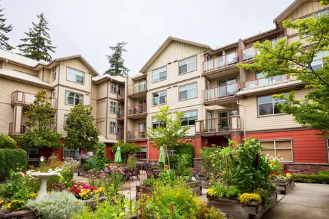 Residence exterior overlooking raised garden beds and a courtyard