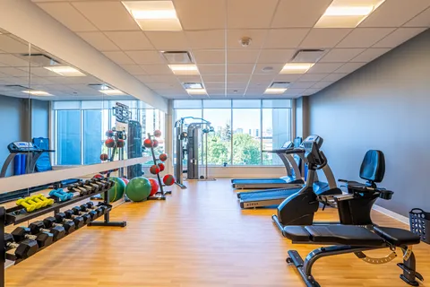Fitness room with exercise machines and free weights.