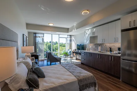 Studio suite with a bed, sofa and kitchenette.